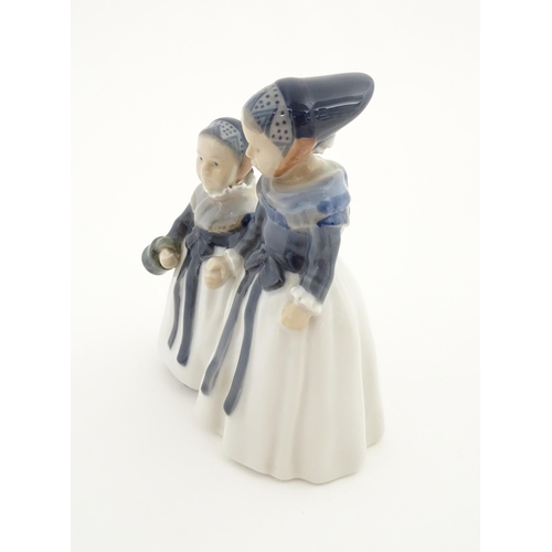 87 - A Royal Copenhagen figural group depicting two Amager girls in traditional dress, model no. 1316. Ma... 