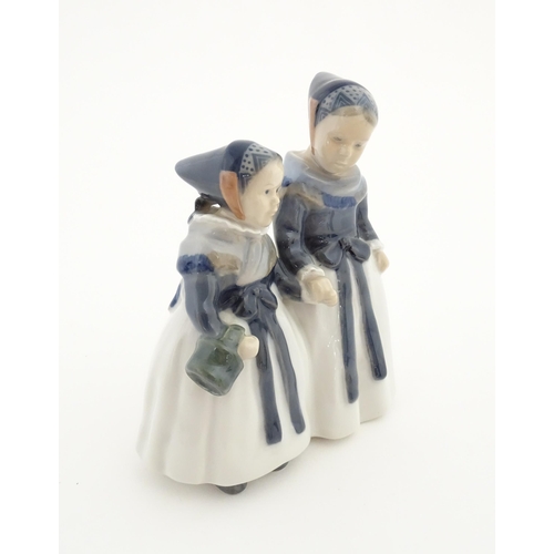 87 - A Royal Copenhagen figural group depicting two Amager girls in traditional dress, model no. 1316. Ma... 