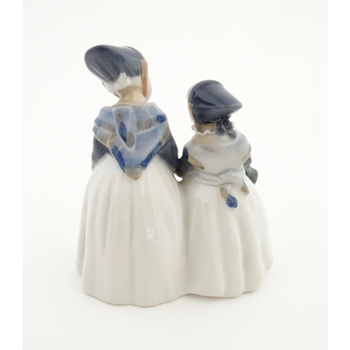 87 - A Royal Copenhagen figural group depicting two Amager girls in traditional dress, model no. 1316. Ma... 