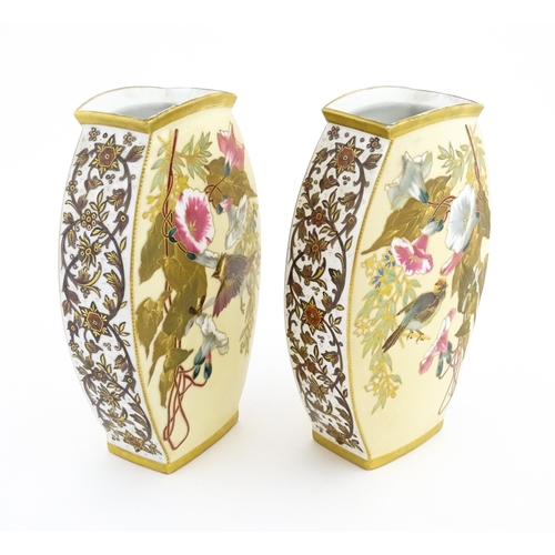 89 - A pair of Limoges Demartial and Tallandier vases of ovoid form decorated with exotic birds, flowers ... 