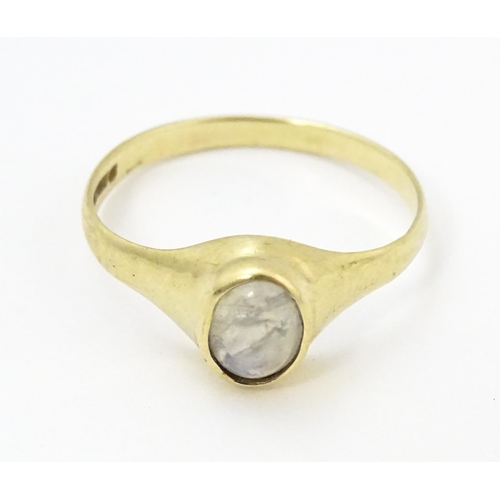 828 - A 9ct gold ring set with central moonstone. Ring size approx. M