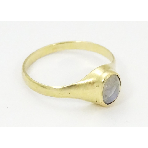 828 - A 9ct gold ring set with central moonstone. Ring size approx. M