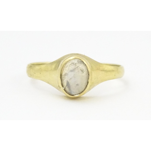 828 - A 9ct gold ring set with central moonstone. Ring size approx. M