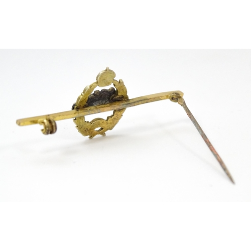 833 - Military Interest : A 9ct gold regimental bar brooch for the Royal Tank Corps depicting insignia wit... 