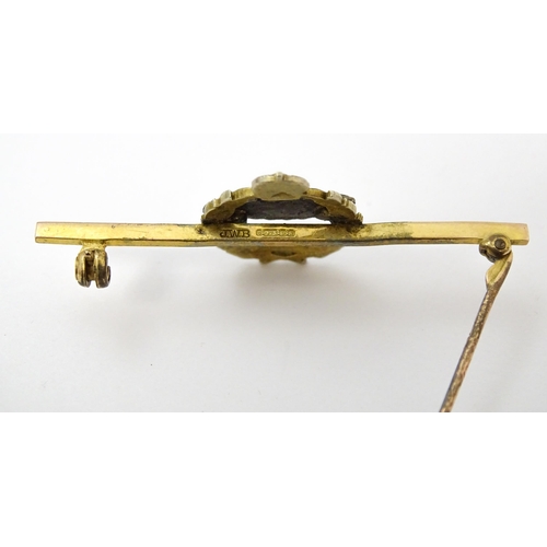 833 - Military Interest : A 9ct gold regimental bar brooch for the Royal Tank Corps depicting insignia wit... 