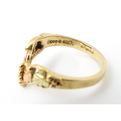 861 - A 9ct gold ring with rose gold detail. Ring size approx. L. Together with a matching pair of drop ea... 