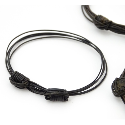 869 - Five assorted early 20thC Elephant hair bracelets, one with gilt metal mounts. (5)