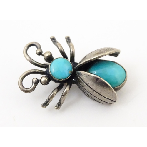 908 - Three assorted brooches / pins to include a silver example formed as a insect / bug set with turquoi... 