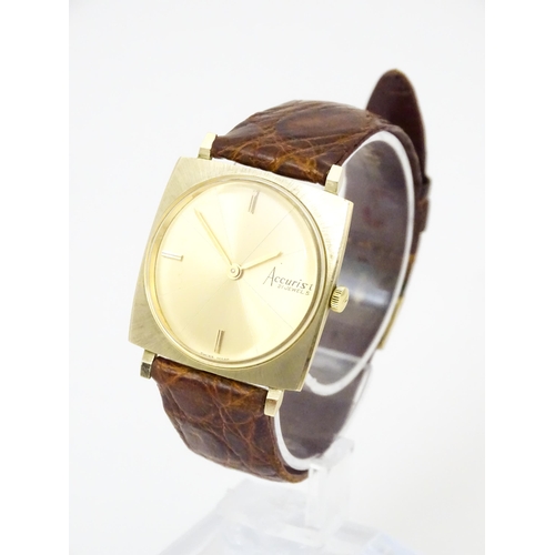 936A - An Accurist 9ct gold square cased slim dress wristwatch, with Accurist leather strap. Watch case app... 