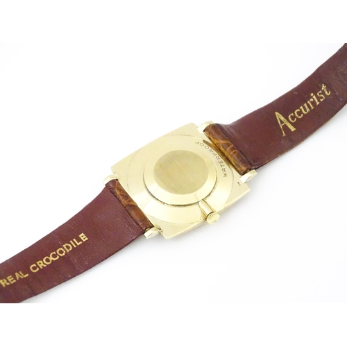 936A - An Accurist 9ct gold square cased slim dress wristwatch, with Accurist leather strap. Watch case app... 