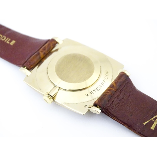 936A - An Accurist 9ct gold square cased slim dress wristwatch, with Accurist leather strap. Watch case app... 