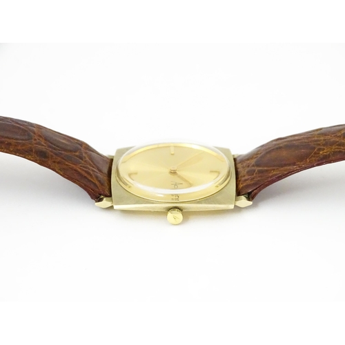 936A - An Accurist 9ct gold square cased slim dress wristwatch, with Accurist leather strap. Watch case app... 