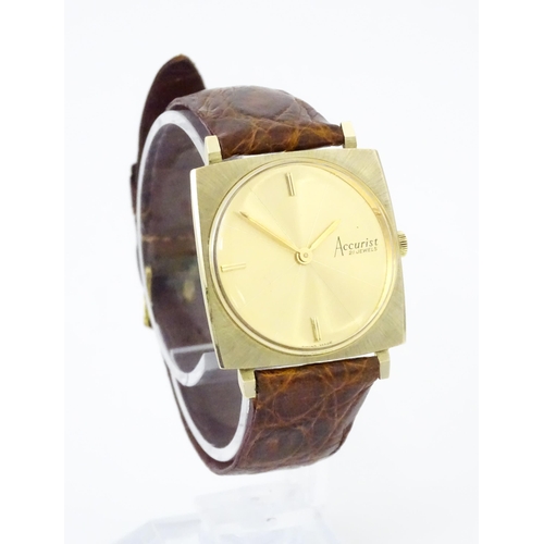 936A - An Accurist 9ct gold square cased slim dress wristwatch, with Accurist leather strap. Watch case app... 