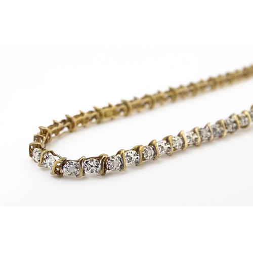 879 - A 9ct gold bracelet set with diamonds. Approx. 7 1/2