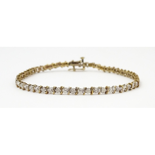 879 - A 9ct gold bracelet set with diamonds. Approx. 7 1/2