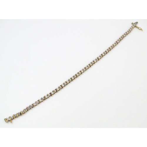 879 - A 9ct gold bracelet set with diamonds. Approx. 7 1/2