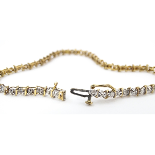 879 - A 9ct gold bracelet set with diamonds. Approx. 7 1/2