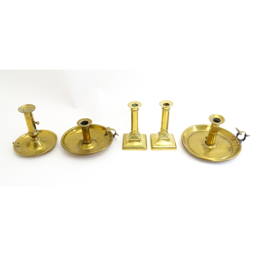 1086 - Five assorted 19thC and later brass candlesticks to include chambersticks, some ejector examples. La... 