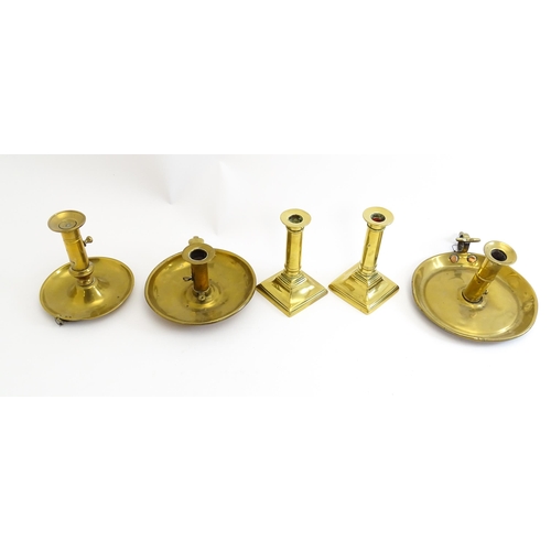 1086 - Five assorted 19thC and later brass candlesticks to include chambersticks, some ejector examples. La... 