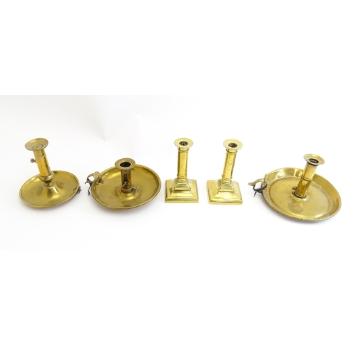 1086 - Five assorted 19thC and later brass candlesticks to include chambersticks, some ejector examples. La... 