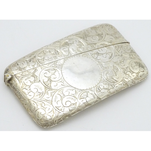 287 - A silver card case of shaped form with engraved scrolling decoration. Hallmarked Birmingham 1905  ma... 