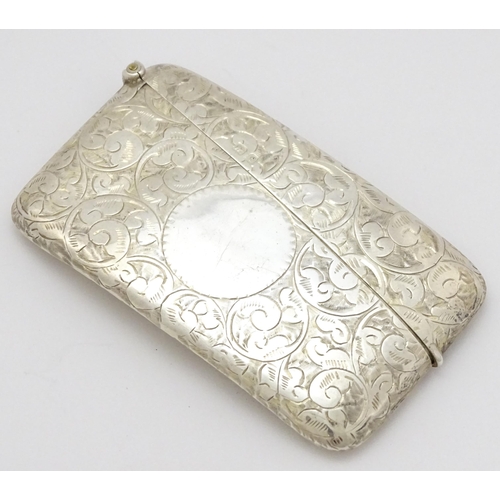 287 - A silver card case of shaped form with engraved scrolling decoration. Hallmarked Birmingham 1905  ma... 