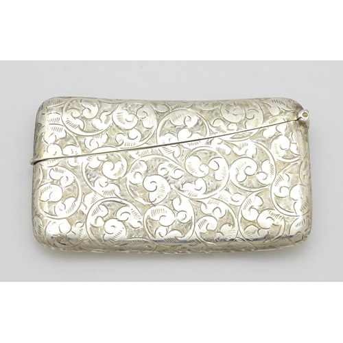 287 - A silver card case of shaped form with engraved scrolling decoration. Hallmarked Birmingham 1905  ma... 