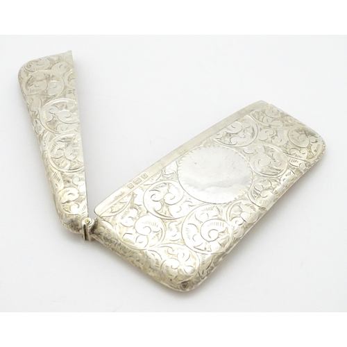 287 - A silver card case of shaped form with engraved scrolling decoration. Hallmarked Birmingham 1905  ma... 