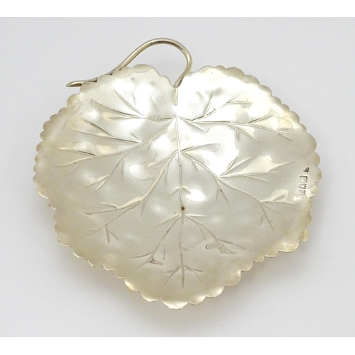 297 - A silver dish of leaf form hallmarked London 1901, maker Heath & Middleton and stamped 16021. Approx... 