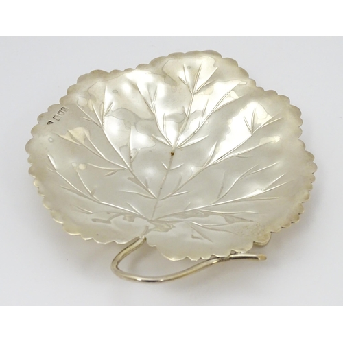 297 - A silver dish of leaf form hallmarked London 1901, maker Heath & Middleton and stamped 16021. Approx... 