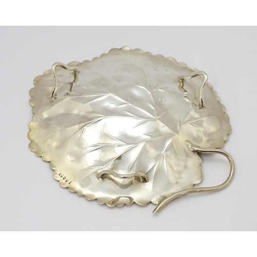 297 - A silver dish of leaf form hallmarked London 1901, maker Heath & Middleton and stamped 16021. Approx... 