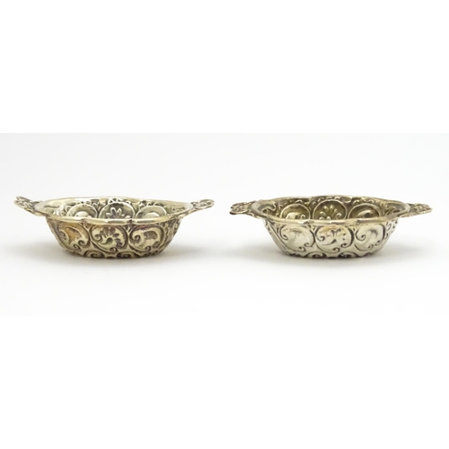 299 - A pair of Victorian silver salts with embossed decoration, hallmarked Chester 1899, maker William Ai... 