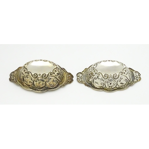 299 - A pair of Victorian silver salts with embossed decoration, hallmarked Chester 1899, maker William Ai... 