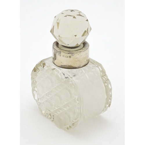 303 - A cut glass scent / perfume bottle with silver collar hallmarked Birmingham 1912, maker C. C. May & ... 