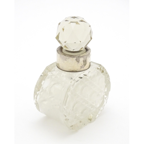 303 - A cut glass scent / perfume bottle with silver collar hallmarked Birmingham 1912, maker C. C. May & ... 