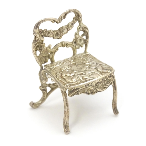 308 - A 19thC Continental .930 silver model of a chair with import marks for London 1897 imported David Br... 