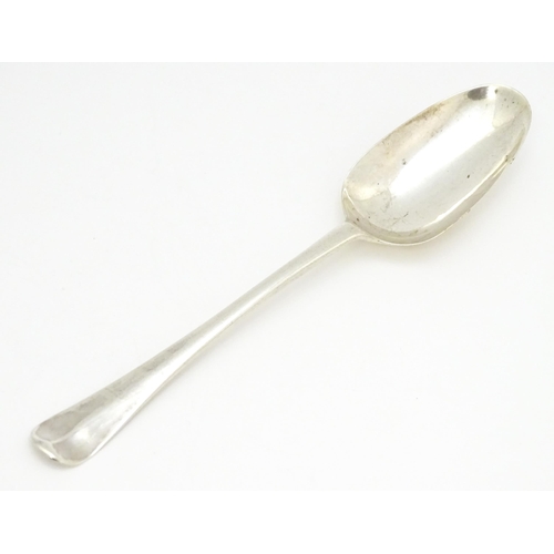 311 - An 18thC silver Hanoverian pattern table spoon hallmarked London 1739, maker Samuel Hutton. Approx. ... 