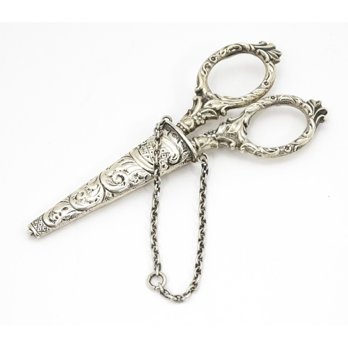 334 - Chatelaine scissors with silver handles and sheath with floral and foliate decoration, hallmarked Ch... 