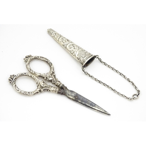 334 - Chatelaine scissors with silver handles and sheath with floral and foliate decoration, hallmarked Ch... 