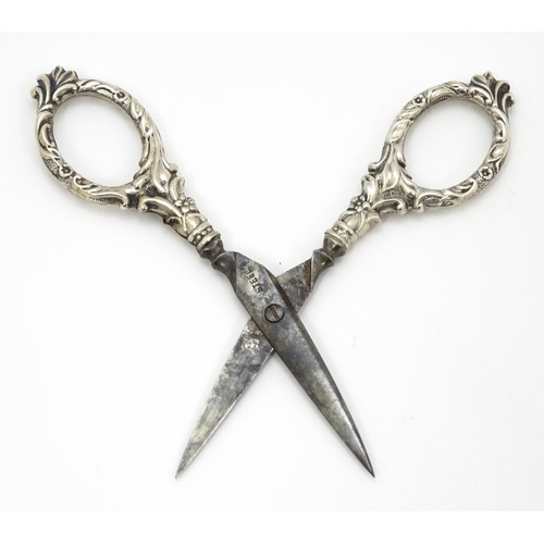 334 - Chatelaine scissors with silver handles and sheath with floral and foliate decoration, hallmarked Ch... 