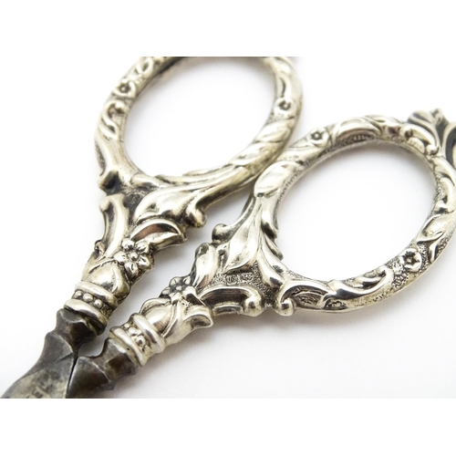 334 - Chatelaine scissors with silver handles and sheath with floral and foliate decoration, hallmarked Ch... 