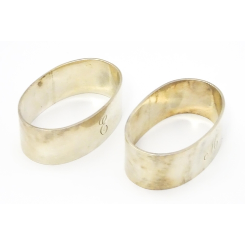 335 - A pair of silver napkin rings of oval form hallmarked Chester 1954, maker Arthur Creighton. (2)