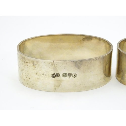 335 - A pair of silver napkin rings of oval form hallmarked Chester 1954, maker Arthur Creighton. (2)