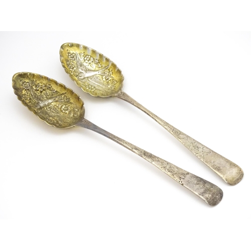 359 - A pair of William IV Irish silver berry spoons, the gilded bowls with embossed flower and bird detai... 