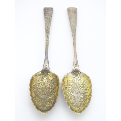 359 - A pair of William IV Irish silver berry spoons, the gilded bowls with embossed flower and bird detai... 