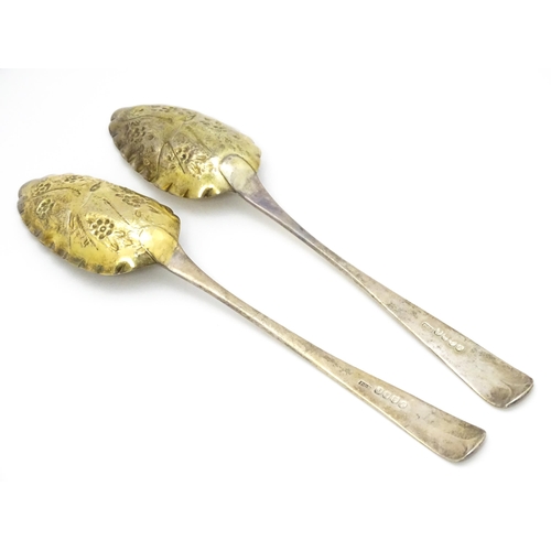 359 - A pair of William IV Irish silver berry spoons, the gilded bowls with embossed flower and bird detai... 