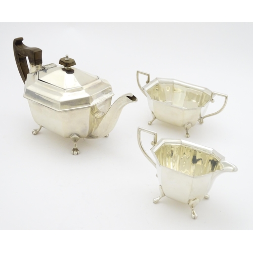 363 - A silver three piece tea set comprising teapot, sugar bowl and milk jug hallmarked Sheffield 1934, m... 