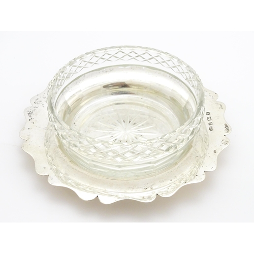 364 - A cut glass butter / preserve dish with silver lid and stand hallmarked Birmingham 1921, maker Alexa... 