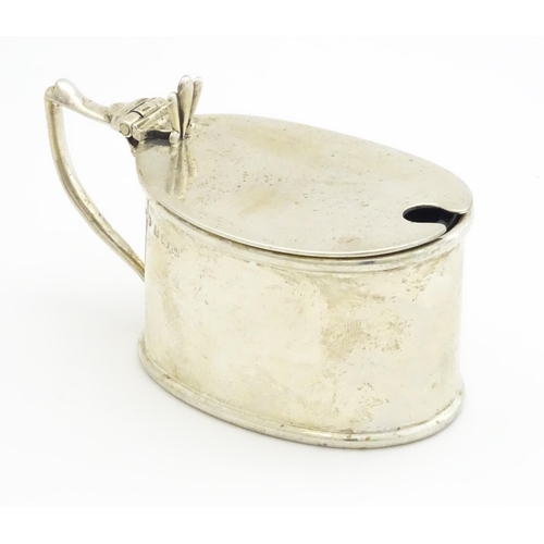 366 - A silver mustard pot with blue glass liner hallmarked Birmingham 1911, maker T H Hazlewood & Co. App... 