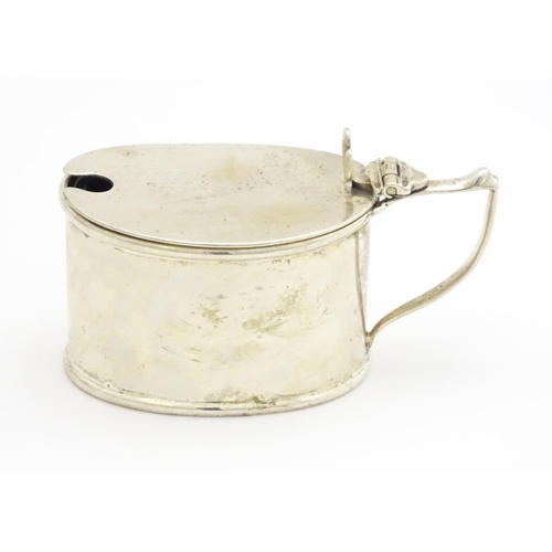 366 - A silver mustard pot with blue glass liner hallmarked Birmingham 1911, maker T H Hazlewood & Co. App... 